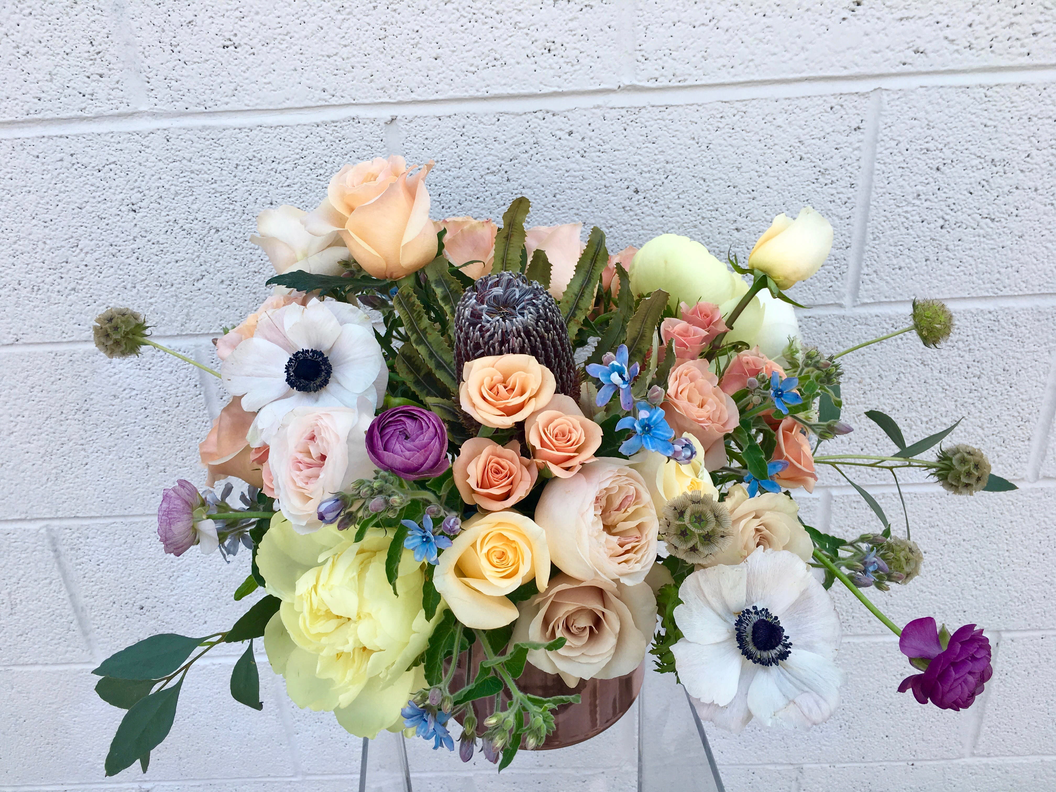  Florist's Picks - Spring Chick  - DUE TO COVID-19, AVAILABILITY MAY VARY. PLEASE CALL FOR DETAILS. ALL ARRANGEMENTS WILL BE DESIGNER'S CHOICE. DELIVERY DATE AVAILABILITY IS SUBJECT TO CHANGE This soft neutral toned arrangement may include a variety of garden roses, anemones, spray roses, tea roses, touches of greenery and other beautifully toned elements fresh from the Miss Daisy cooler! Peonies currently unavailable.   *It's possible that some days we may not have the exact flowers depending on the season, or exact container specified on the arrangement's description. When this is the case, our bouquets are made with flower substitutions or delivered in a different vase than expected by using substitutions of an equal or higher value. If you'd prefer no substitutions, please send an email or call us after placing your order. Please give us at least three days notice if you're looking for an arrangement with no substitutions. White and Coral Mixed Blooms White, Peach Miss Daisy Jessica Marshall Substitution Policy  In some instances, the florists photo may represent an overall theme or look and include a one-of-a-kind vase which cannot be exactly replicated. Although the actual bouquet may not precisely match the photo, its temperament will. Occasionally, substitutions of flowers or containers happen due to weather, seasonality and market conditions which may affect availability. If this is the case with the gift you've selected, the local florist will ensure that the style, theme and color scheme of your arrangement is preserved and will only substitute items of equal or higher value.
