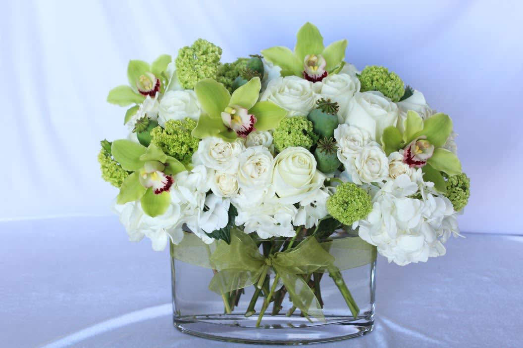Put Your Money On Me - This large white and green designer's choice arrangement is the perfect color combo for any occasion! It's a fresh look that will brighten up any space and be sure to put a smile on a face!  *It's possible that some days we may not have the exact flowers depending on the season, or exact container specified on the arrangement's description. When this is the case, our bouquets are made with flower substitutions or delivered in a different vase than expected by using substitutions of an equal or higher value. If you'd prefer no substitutions, please send an email or call us after placing your order. Please give us at least three days notice if you're looking for an arrangement with no substitutions.