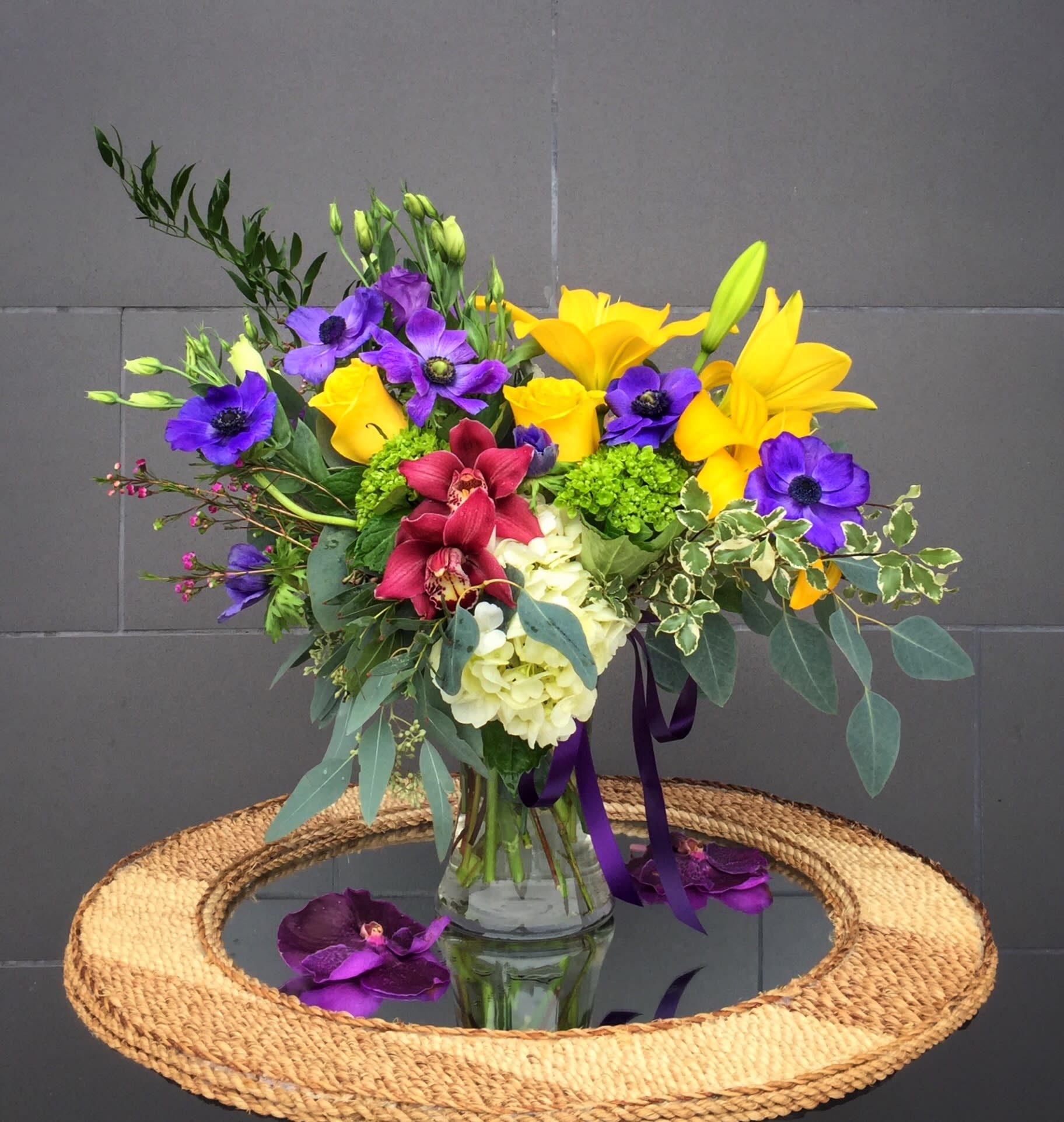Vibrant Floral Medley - A colorful design including all premium flowers: lily, orchid, rose, lisianthus... and nice accents. STANDARD: FIRST PHOTO DELUXE: SECOND PHOTO