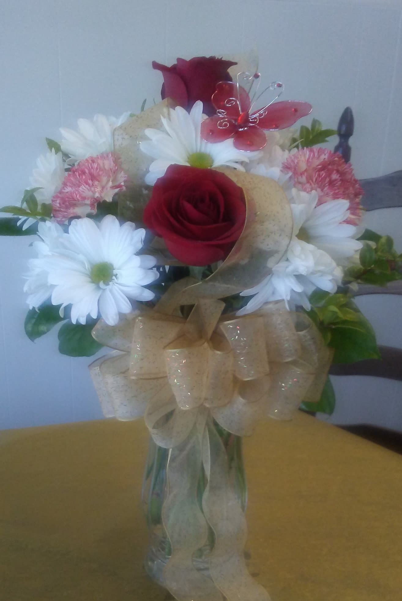 Anniversary Day Anniversary Day - Red roses and daisies, elegant and casual, terrific for any year to celebrate their special day.