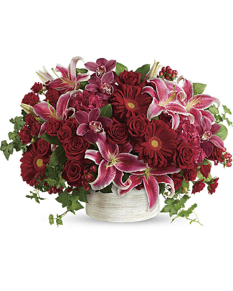 Stunning Statement Bouquet Stunning Statement Bouquet - Brimming with hydrangea orchids roses and lilies in fabulous fuchsias and radiant reds this breathtaking bouquet definitely makes a statement! This stunning arrangement of red hydrangea red cymbidium orchid blossoms red roses red spray roses hot pink oriental lilies red gerberas and red hypericum is accented with green ivy and lemon leaf. Delivered in a white cylinder planter.