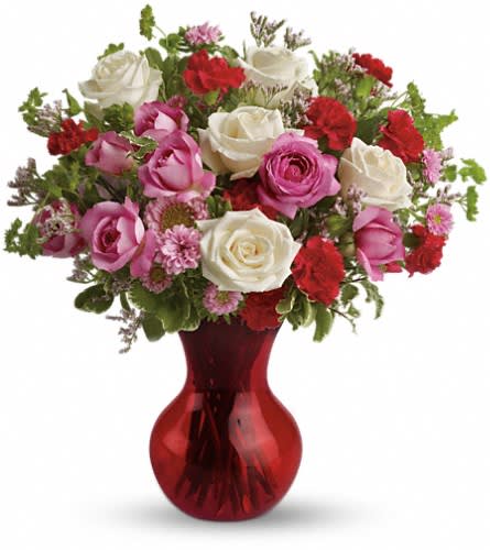 Teleflora's Splendid in Red Bouquet with Roses Teleflora's Splendid in Red Bouquet with Roses - A sweet traditional bouquet in a red-hot contemporary vase it's a great way to make that surprise party even more so! They'll love the gift and you'll love the surprisingly low price tag. The enchanting bouquet includes white roses medium pink roses hot pink carnations light pink matsumoto asters and lavender limonium accented with assorted greenery. Delivered in a sparkling red Serendipity vase.Approximately 16" W x 16 1/2" H Orientation: One-Sided As Shown : TEV07-3ADeluxe : TEV07-3BPremium : TEV07-3C