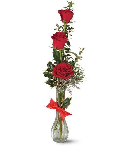 Teleflora's Rose Trio Vase - Festive yet serene this trio of lush red roses accented with evergreen and holly is the perfect Christmas remembrance for neighbors teachers friends and so many others on your list. Glass bud vase with a bouquet containing red roses misty blue limonium variegated holly myrtle and white pine. Tied with red satin ribbon. Approximately 19&quot; H x 6&quot; W As Shown : TF-X1 Available for local delivery only