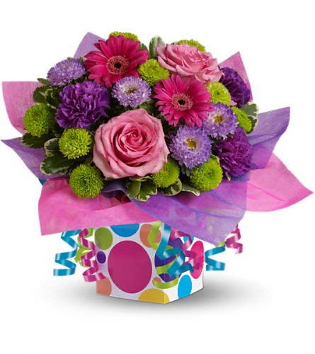 Teleflora's Confetti Present Teleflora's Confetti Present - Flowers and presents make festive gifts especially when they are paired together! This happy bouquet includes pink roses hot pink miniature gerberas purple carnations and asters and green button spray chrysanthemums accented with fresh greenery. Delivered in a festive gift box accented with hot pink and purple water-resistant tissue paper and ribbon streamers for a truly unique birthday gift.Approximately 17" W x 13 1/2" H Orientation: One-Sided As Shown : T15-1ADeluxe : T15-1BPremium : T15-1C