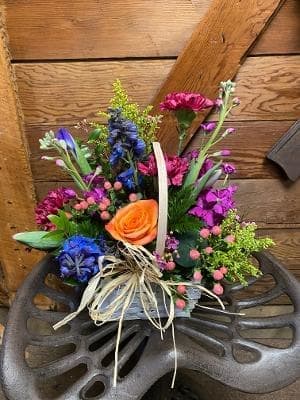 Majestic Blooms - This stunning basket is filled with a vast array of blooms.  Including, roses, carnations, stock and other in season flowers. 
