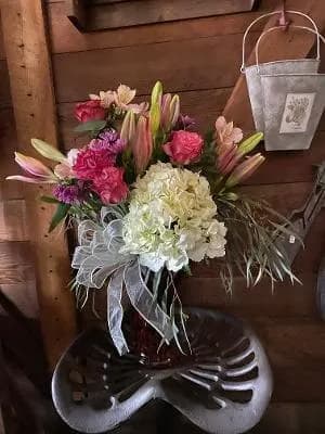 Divine  - This divine bouquet is filled with charm and elegance. This hand gathered bouquet is filled with  roses, carnations, lilies and other seasonal flowers. 