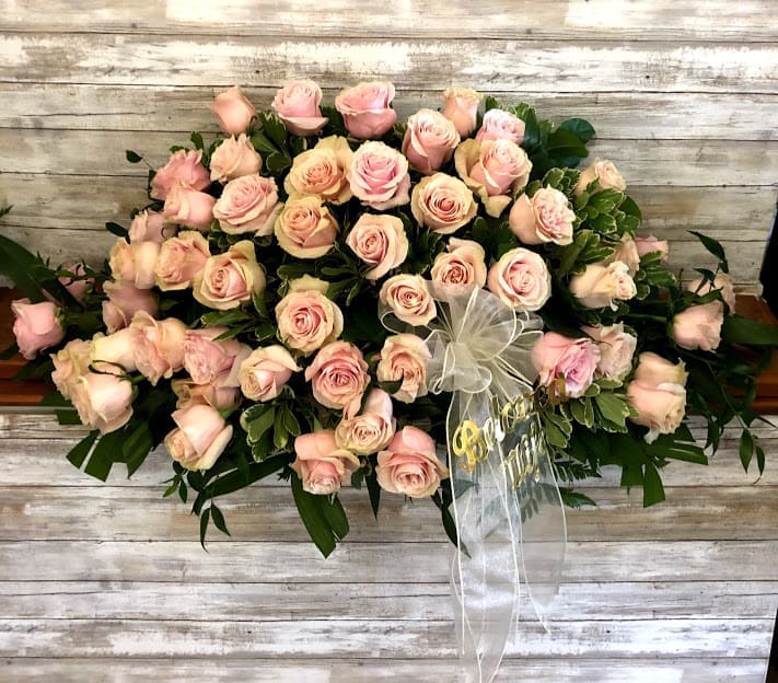 Pink Rose Casket Spray Half-Size for Open Casket - What a peaceful farewell tribute - A Half-Casket spray of all pink roses accented with greenery.  Full Size Also Available
