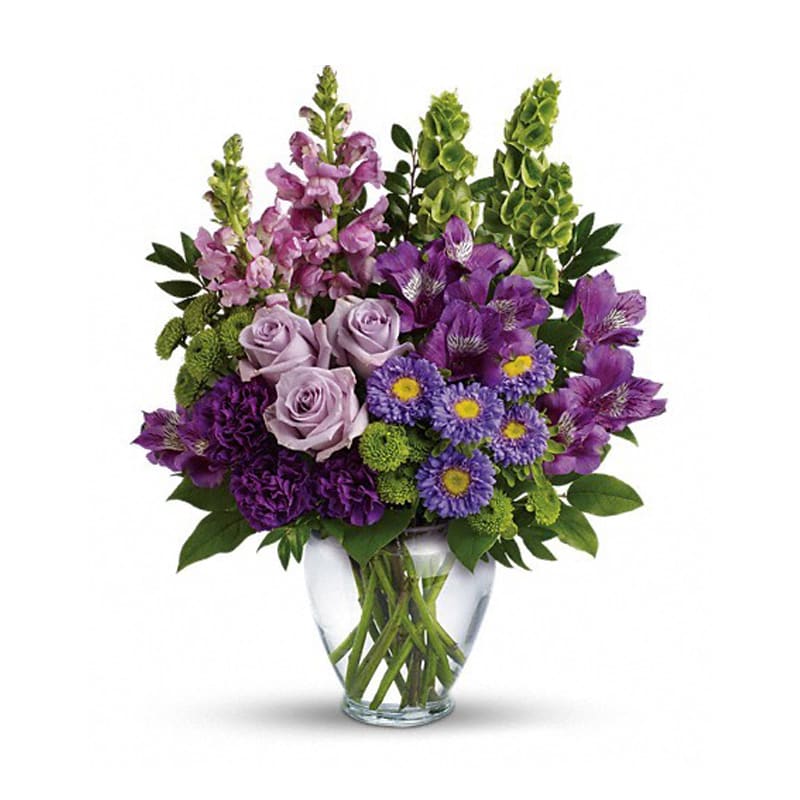Lavender Charm Bouquet - A soothing sea of lavender, this beautiful bouquet blends luxurious roses and alstroemeria with playful snapdragons and bells of Ireland. It's a charming, cheerful gift for any occasion! Approx. 14 1/2 W x 17 1/2 H 