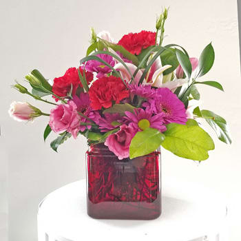 For You Only - A wonderful mix of flowers in a red cube.  Carnations, lisianthus, stargazer lily...petite and catches your eye.