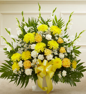 Heartfelt Tribute Floor Basket Arrangement - When dealing with the loss of a family member, friend or colleague, finding the perfect expression of sympathy can be difficult. Featuring a tasteful gathering of fresh yellow roses, white carnations and more, our heartfelt floor basket arrangement will help you convey all the comfort and support that’s in your heart when words just don’t seem to be enough.