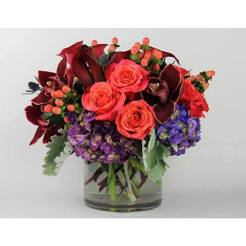 Carnival Pop Bouquet - This colorful arrangement is made with Coral Ecuadorian Roses, Calla Lilies, Hydrangeas, and other exotic blooms. Product ID: 3011 