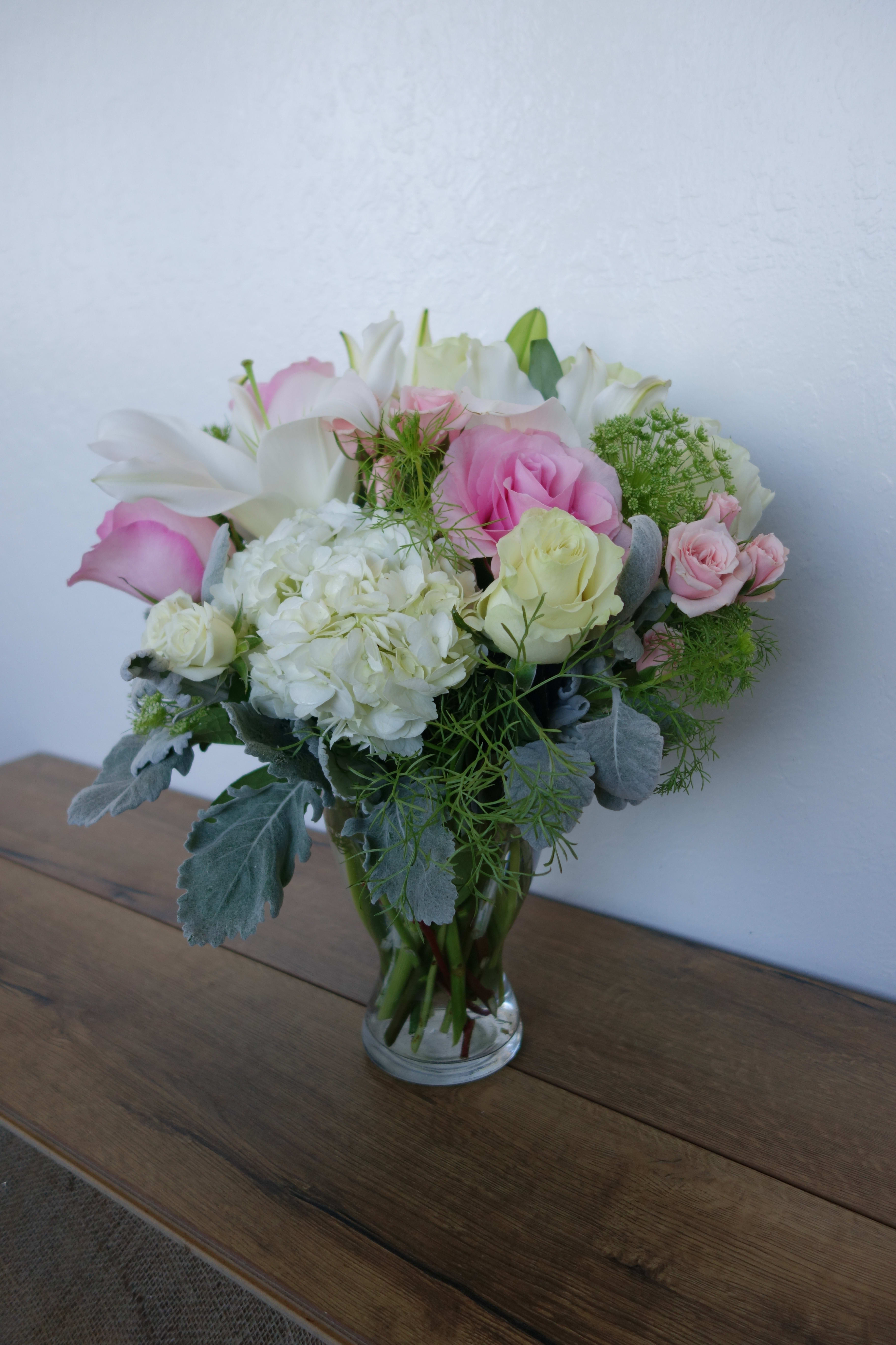 New Light - Soft and elegant, hues of pink and white, give this arrangement just one try... you'll see it in a new light. This arrangement features roses, lilies, hydrangeas, and mixed foliage.  Orientation: All-Around