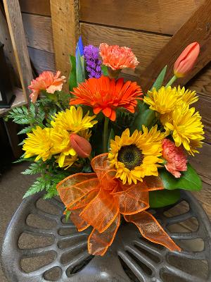 Sweet Orange  - This bright arrangement is filled with yellow, purple, orange flowers from the season. It is hand designed with carnations, daisies, mums and seasonal flowers. 