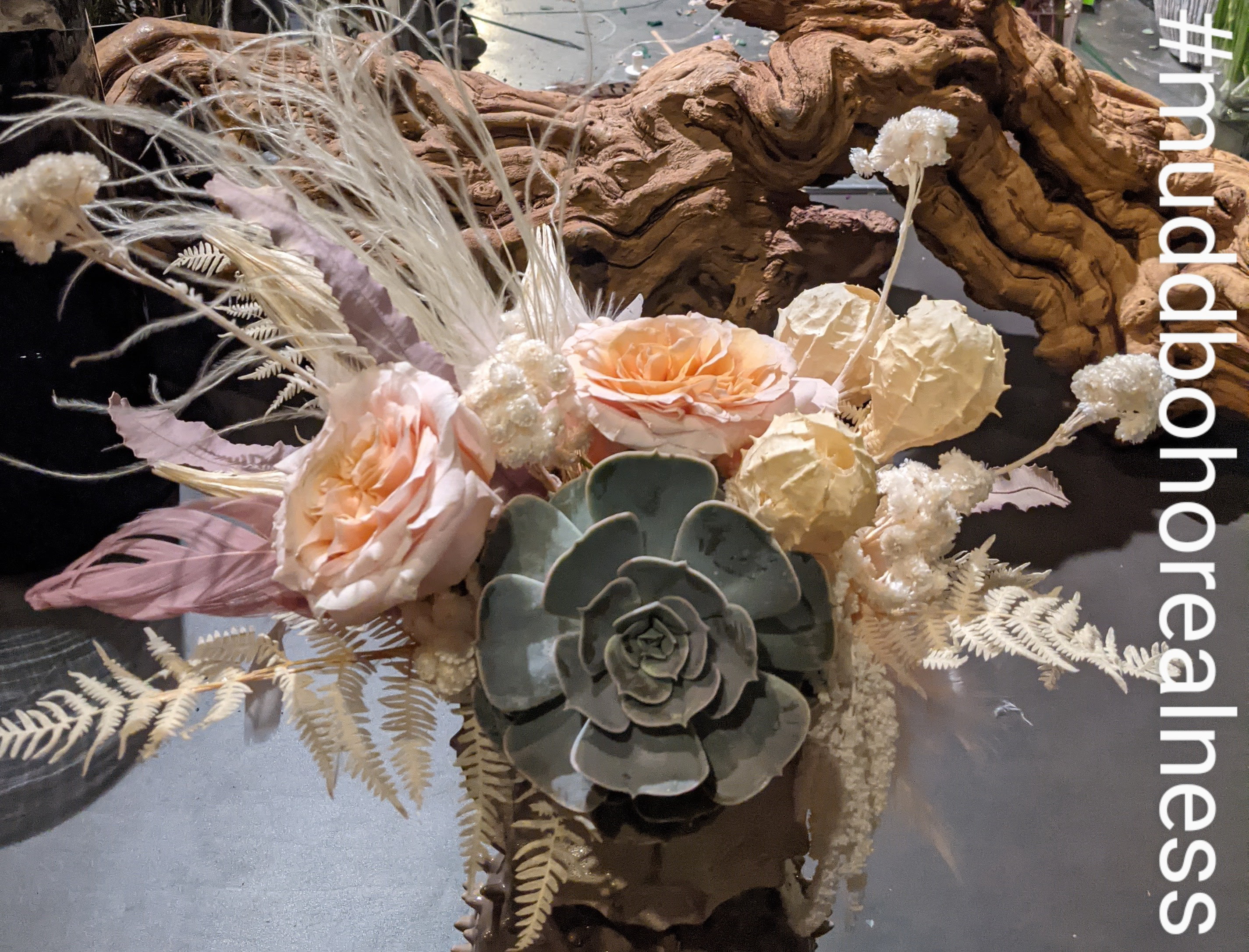 Pinky Peachy Boho Mini Mudd Pinky Peachy Boho Mini Mudd - This textural but feminine design is filled with bleached and preserved wildflowers , a dutch succulent and blush roses.