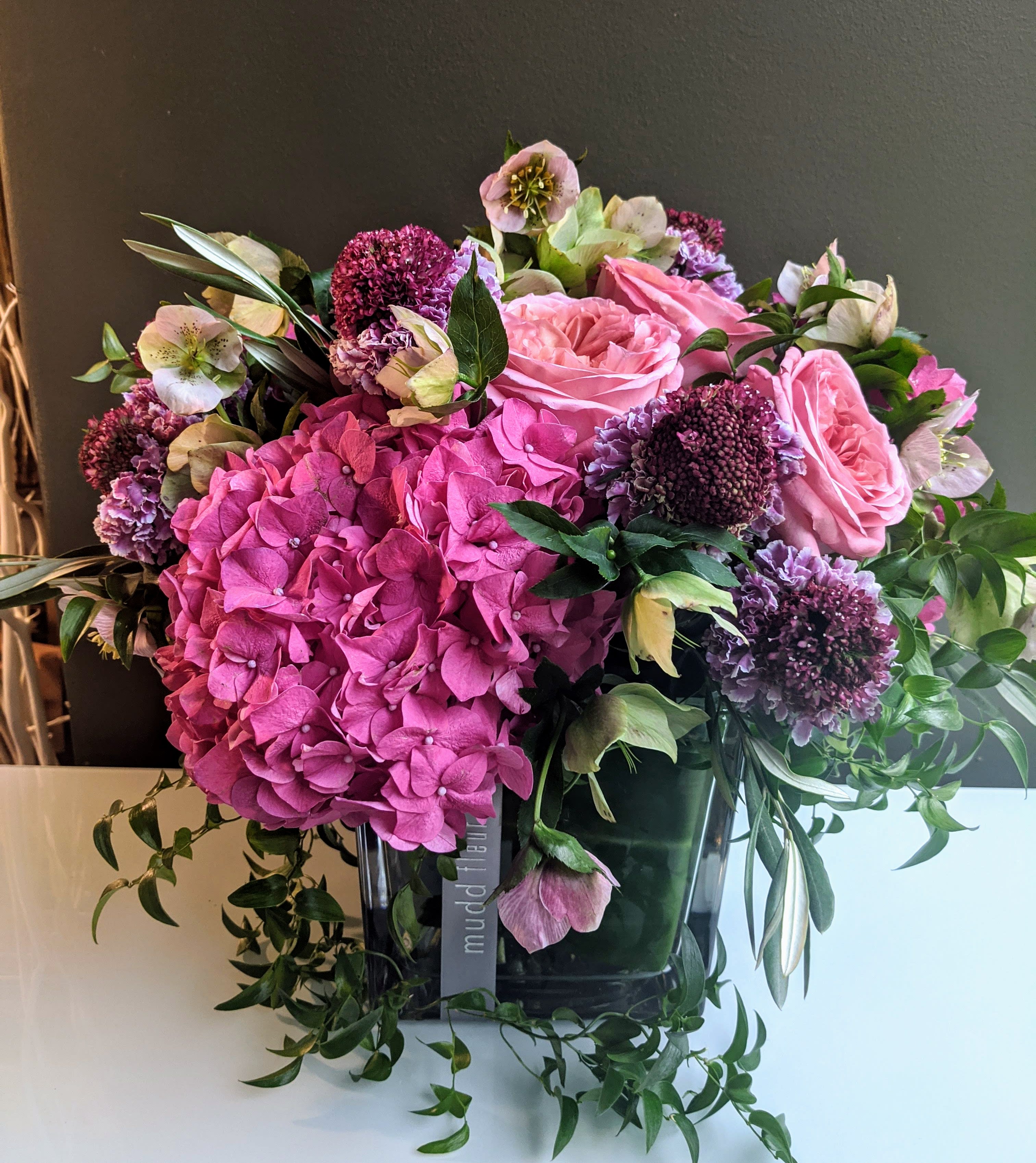 Textural English Garden Gift Arrangement Textural English Garden Gift Arrangement - Hydrandea, garden style roses, sweet peas(in season), scabiosa, hellebores, and fresh cut jasmine or other garden ivy or dangling vines bring your mind to a goprgeopus summer day in the garden, not a hellish Chicago Winter!!!!