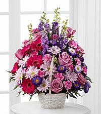 The FTD® Pastel Peace™ Basket - The FTD® Pastel Peace™ Basket is a sweet and simple way to offer your condolences. Lavender roses, fuchsia gerbera daisies, lavender daisies, purple larkspur, purple matsumoto asters, pink mini carnations and lush greens are arranged to perfection in a round whitewash handled basket to create a gift that expresses your wishes for sympathy and peace