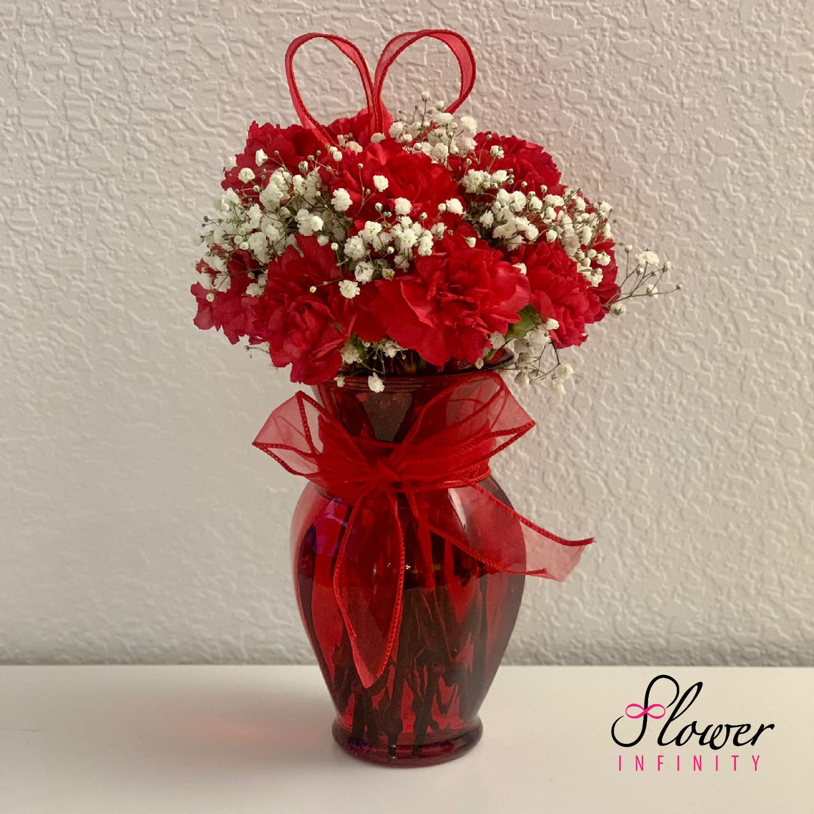 Red Hearts by Flower Infinity  - A perfectly balanced carnation piece consisting of vibrant red colors. 