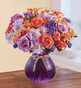 Plum Crazy for Fall Plum Crazy for Fall - Product ID: 99165 EXCLUSIVE We admit it, we're crazy about this colorful bouquetâ¦and we bet theyâll be, too! A colorful mix of orange roses, lavender daisy poms and more is accented with unique dried oak leaves for some added Autumn charm. Hand-crafted in a striking purple glass vase by our expert florists, itâs a gift that'll leave them "ooh-ing" and "aah-ing", whatever the occasion. Arrangement of orange roses, fuchsia stock and purple daisy poms hand-gathered with variegated pittosporum and dried oak leaves Artistically designed by our select florists in a purple glass vase; measures 7"H Large arrangement measures approximately 14"H x 12"L Medium arrangement measures approximately 13"H x 11"L Small arrangement does not include hypericum and measures approximately 12"H x 10"L Our florists select the freshest flowers available, so colors, varieties and container may vary due to local availability