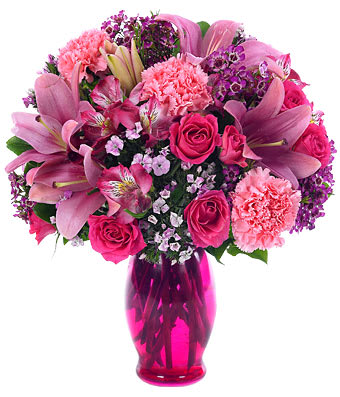 Pink Petals Bouquet - Pretty in pink, and a most-wanted addition to anyone's life. Magnificent carnations, spray roses, Asiatic lilies, alstroemeria and dianthus...all in pink...joins waxflower in a pink fluted vase. Small Measures 14&quot;H by 11&quot;L. Medium Measures 15&quot;H by 12&quot;L. Large Measures 16&quot;H by 13&quot;L