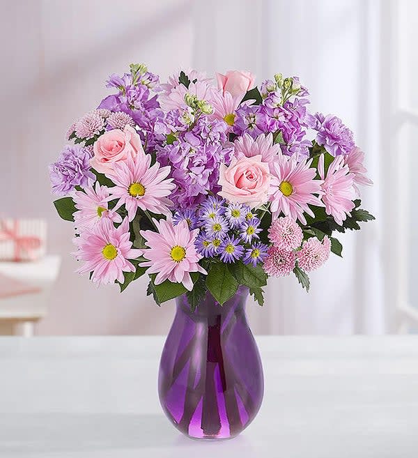 Daydream Bouquet - Just like a daydream, our delightful lavender bouquet is a gift that will linger on their mind. Hand-gathered with pops of pink and lush greenery, it arrives in our striking violet purple vase to capture its rich beauty, along with the thoughtfulness of your sentiment.