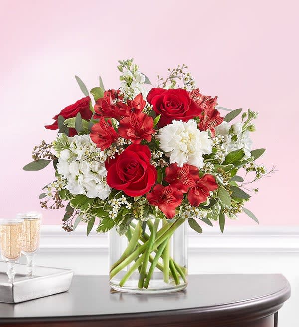 Crimson Rose Bouquet Crimson Rose Bouquet - A classic gift for the people and moments worth celebrating. Rich red and pristine white blooms are hand-gathered with lush greenery. A clear glass cylinder vase holds this beautiful surprise, which brings your deepest sentiments to light.