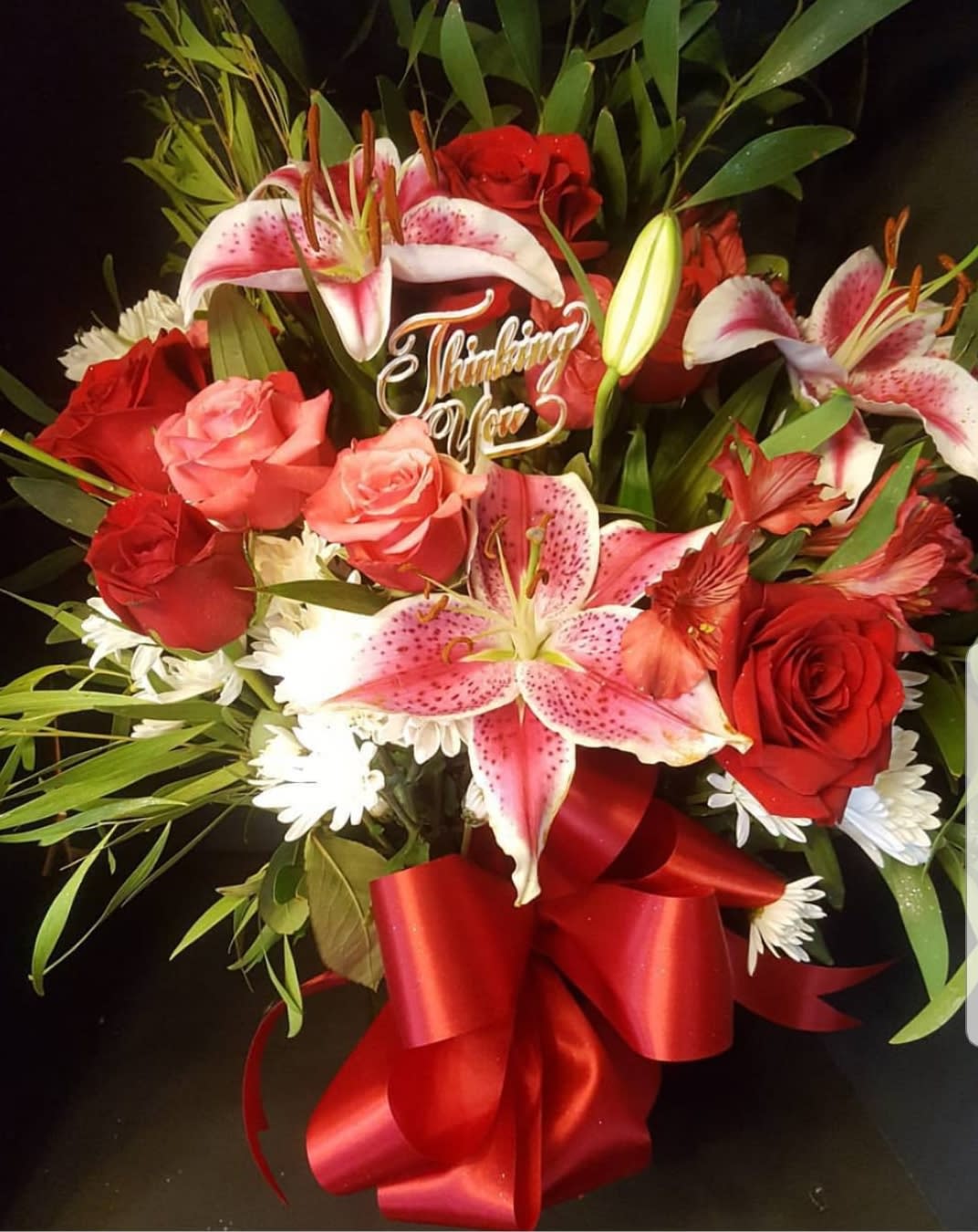 The Thoughtful Bouquet The Thoughtful Bouquet - Red, pink, white roses, asiatic lilies and carnations in a vase adorned with a red or pink ribbon.