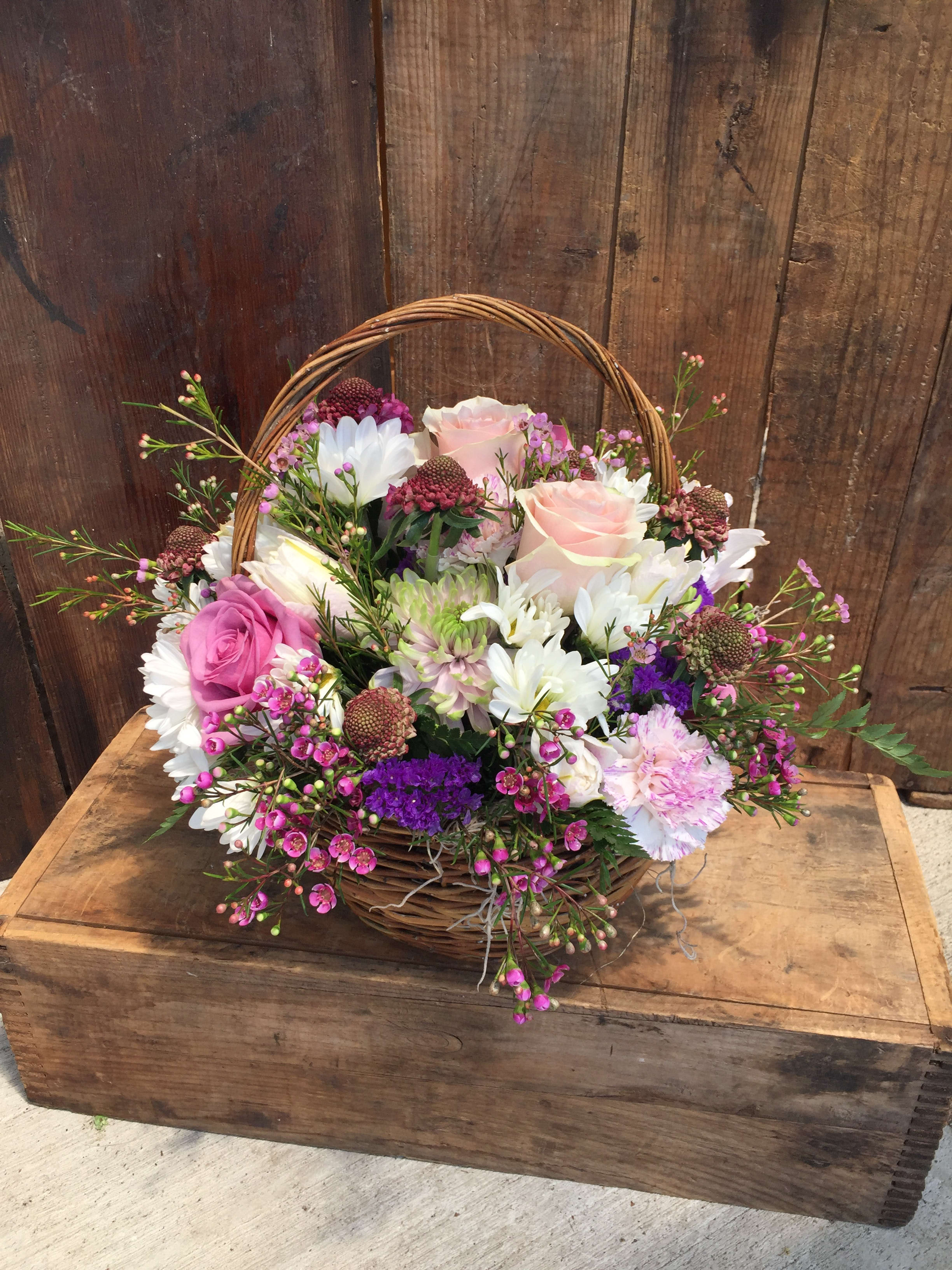 Basket of Feel Good Pinks - A basket of Seasonal Pink Blooms, ideal for a desk or small side table. A perfect gift for a wonderful Mother.