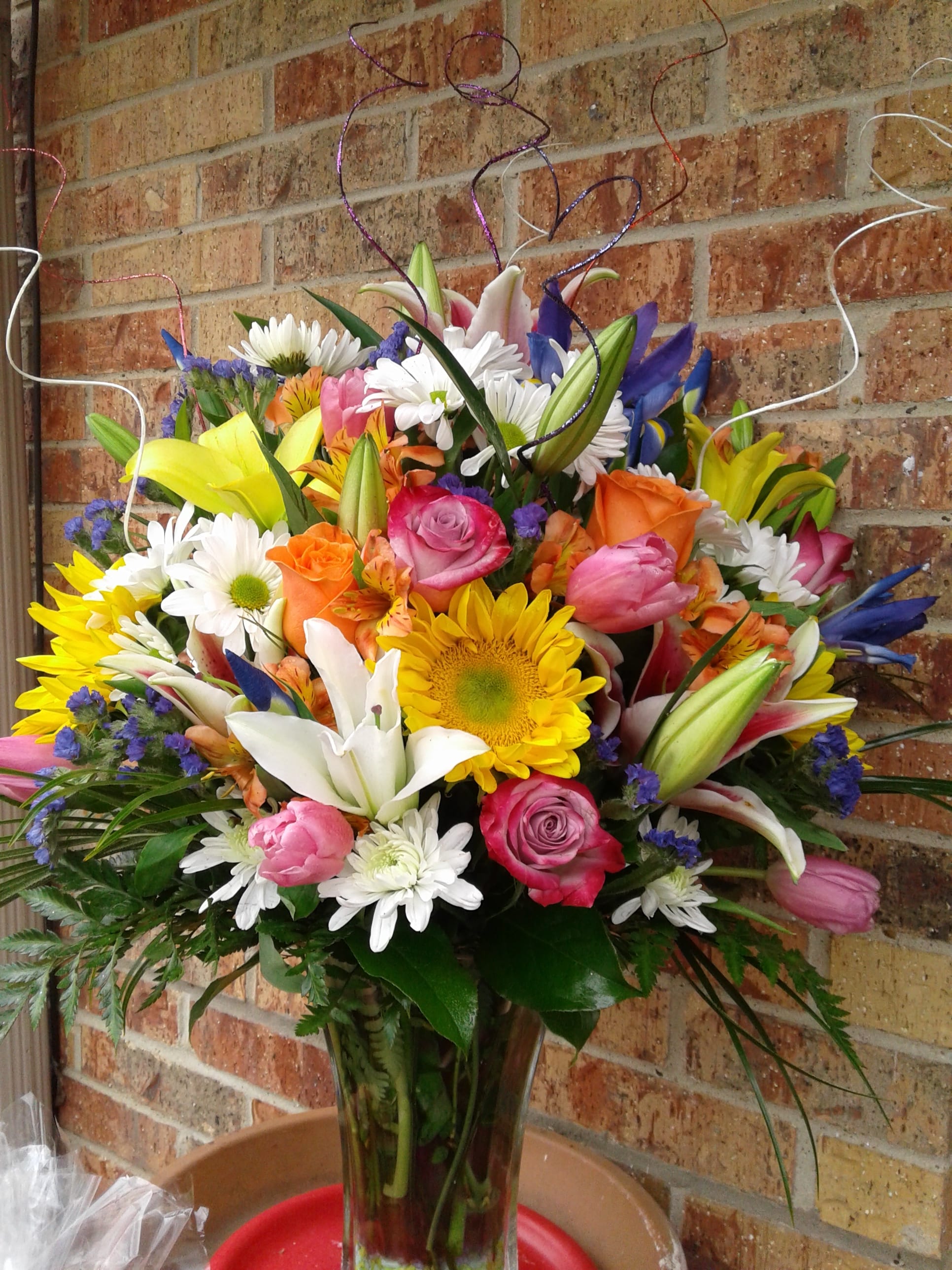 Cheerful Blooms Cheerful Blooms - Send some cheer to your loved one for their birthday, get well or just because with this bright cheerful blooms of fresh flowers designed in a basket or vase with sunflowers, lillies, roses and different filler flowers and greenery added.