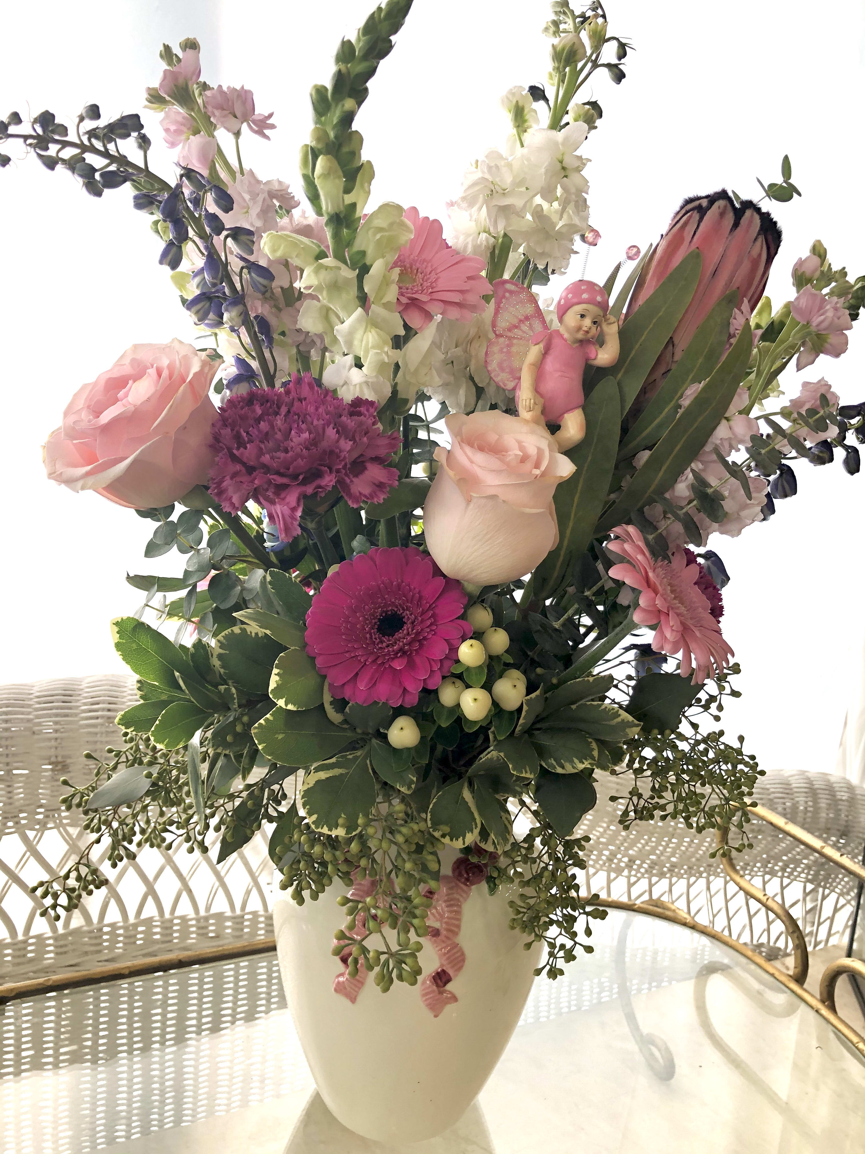 Welcome Baby Girl - Shades of pink, designed with seasonal blooms and greens. Well placed Fairy baby.