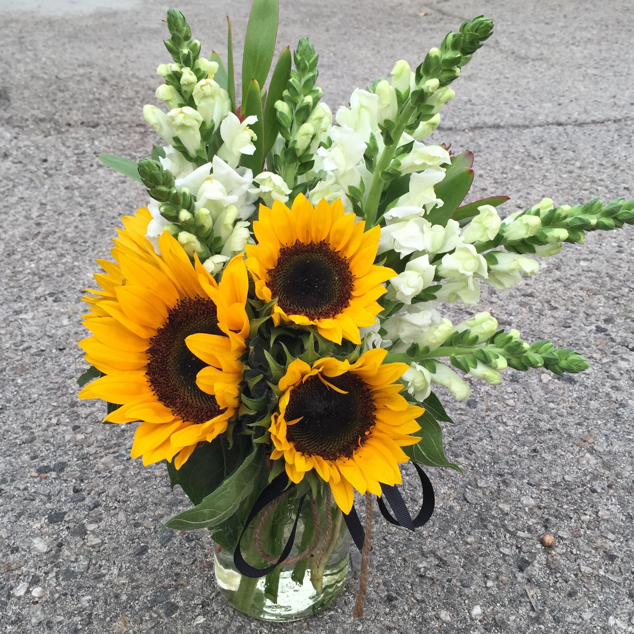 Hey, Sunny! - A full and bright gift of Sunflowers and white Snapdragons in a vintage inspired mason jar. Simple and sweet, this is a great desk sized gift. 