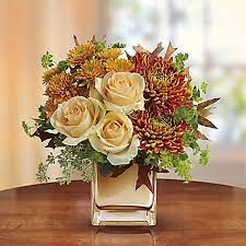 Teleflora's Autumn Romance Bouquet - This elegant bouquet features creamy peach roses, gold cushion chrysanthemums, bronze disbud chrysanthemums, bupleurum, seeded eucalyptus and oak leaves. Delivered in an exclusive bronze Mirrored Cube vase. Approximately 12 1/2&quot; W x 12 1/2&quot; H. TFL05-1A