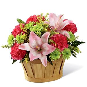 Thinking of You Basket - An natural woodchip basket holds a pretty bouquet of pink Asiatic lilies with hot pink carnations, yellow solidago, green button poms and mixed greens. This is a wonderful gift to let them know they are in your thoughts.  Please note that the BEST version of this basket also includes hot pink roses in addition to hot pink carnations.  At this time the exact basket shown is not available. We will substitute with a very similar wicker basket that will look wonderfu