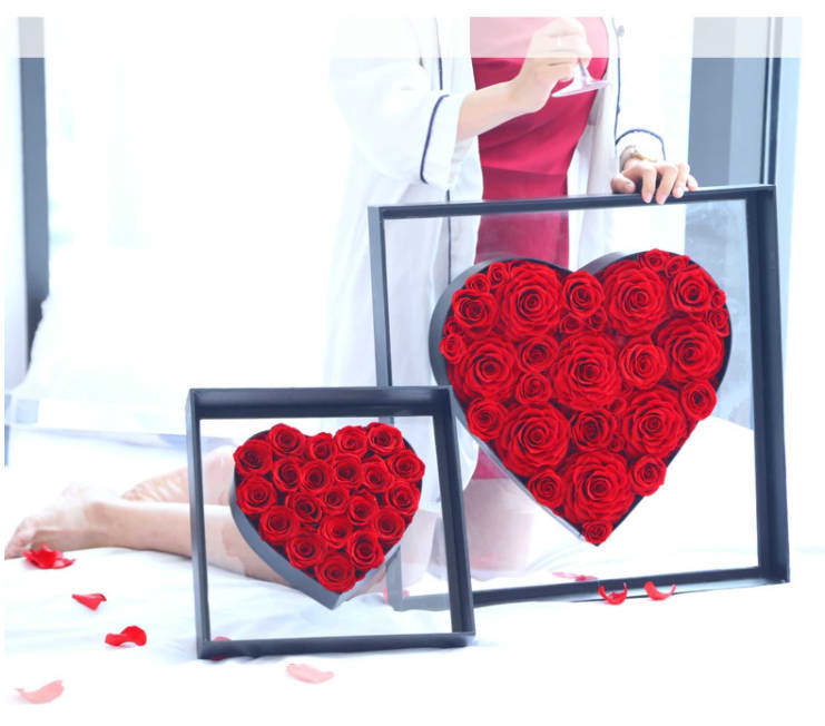 Luxurious Angel Heart Red Box - Send this extraordinary Modern RED Rose Arrangement today.  You can request any other natural color Roses like White, Yellow, Lavender, Pink !  One of the most luxurious heart shaped Red ROSE arrangement inside an acrylic angel heart style box. Impressively sized and absolutely stunning in every possible way; from the smooth and sleek heart-shaped box to the 40-50 Red Ecuadorian  roses professionally arranged inside . This gorgeous arrangement will make anyone instantly see how much you love them. Just the floral display your one and only someone will immediately fall in love with. The ultimate gift for sending extraordinary beauty to brighten the day of the love of your life, from the moment this remarkably arrangement arrives they won't be able to stop themselves from smiling every time they see it.  Send this extraordinary Modern Red Rose Arrangement today.  