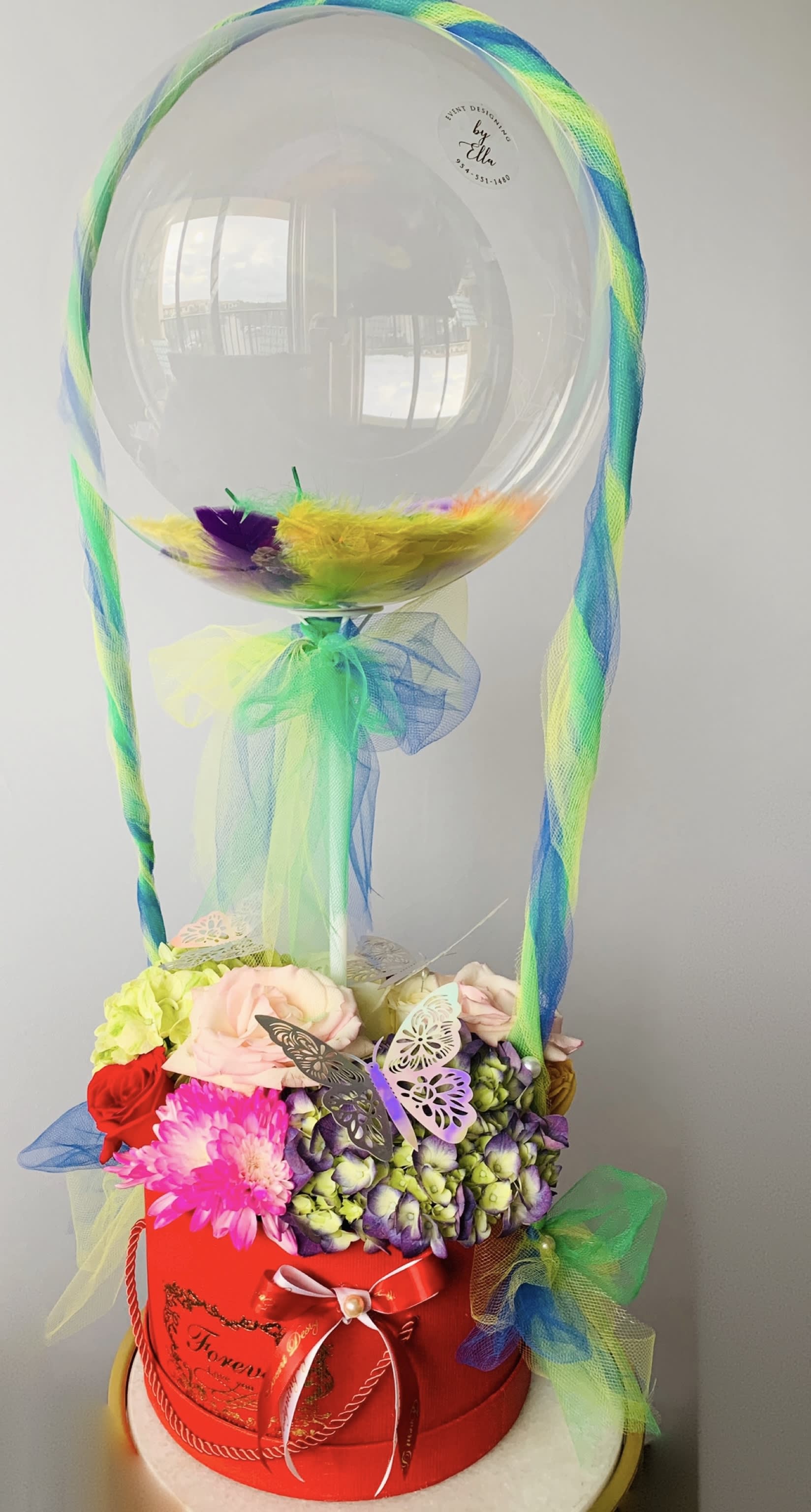 Festival - Fresh bright color  flower arrangement with fathers inside the bubble balloon. Can be decorated with butterflies, if requested