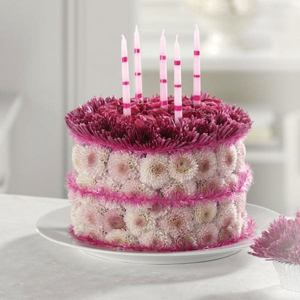 Blooming Birthday Cake Blooming Birthday Cake - They'll never forget this incredible birthday surprise! Spray roses, pompons and mums create a fun-filled, fat-free birthday greeting.