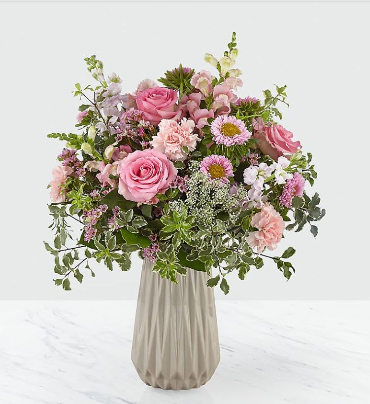 Lovely Elegance Bouquet Lovely Elegance Bouquet - THE VASE HAS BEEN DISCONTINUED, WE WILL SUB WITH COMPARABLE VASE. Our Lovely Elegance bouquet is a majestic combination of pink hues, adding a remarkable touch to any room. Made up of roses, carnations, asters, stock, snapdragons, Queen Anne's lace, and waxflower, this bouquet is perfect for expressing every kind of love. GOOD bouquet is approx. 20"H x 15"W. BETTER bouquet is approx. 20"H x 16"W. BEST bouquet is approx. 21"H x 18"W.