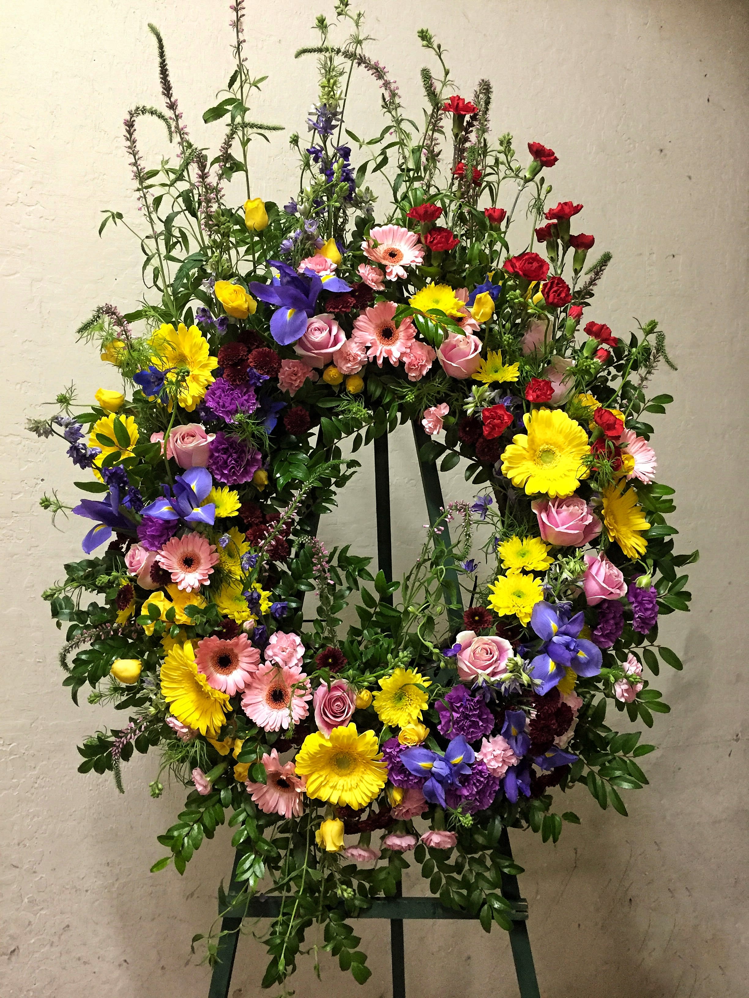 Memorial Garden - Beautiful wreath including rose, iris, gerbera, carnation... and accents.