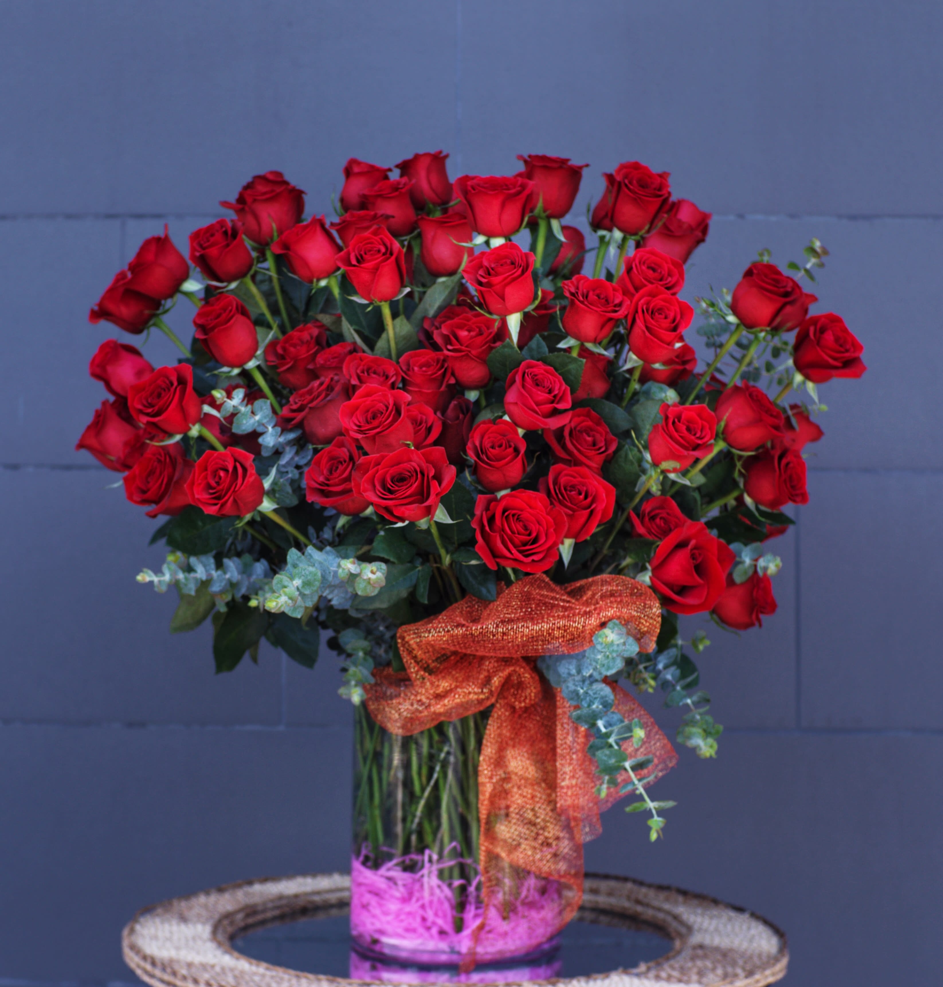 Statement of Love - Beautiful 100 Ecuadorian red roses and nice accents in a big glass vase is a perfect statement of Love. CUSTOMER CAN CHOOSE ANY COLOR OF ROSE.
