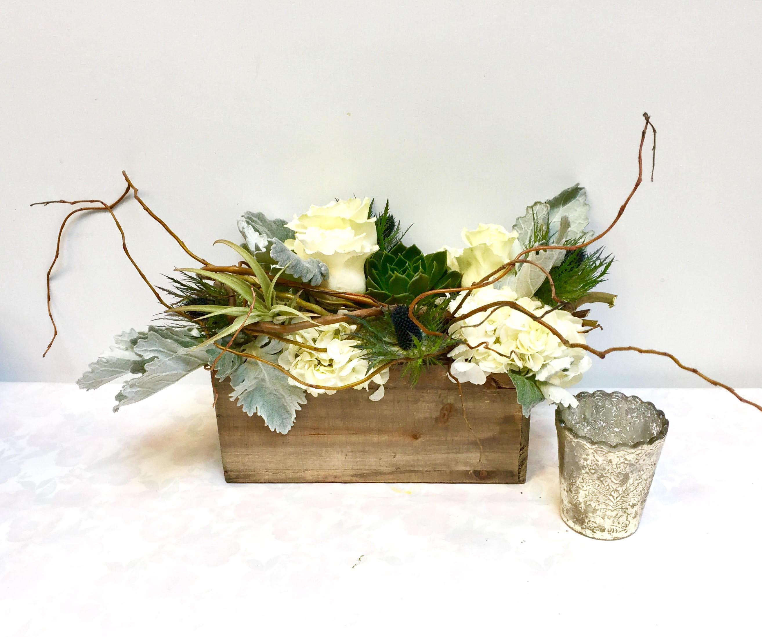 Botanical Garden by Hudson Flower Shop - A stunning garden mix of roses, dusty miller, hydrangea, succulent, air plant and thistle in a substantial size rustic wooden rectangle.