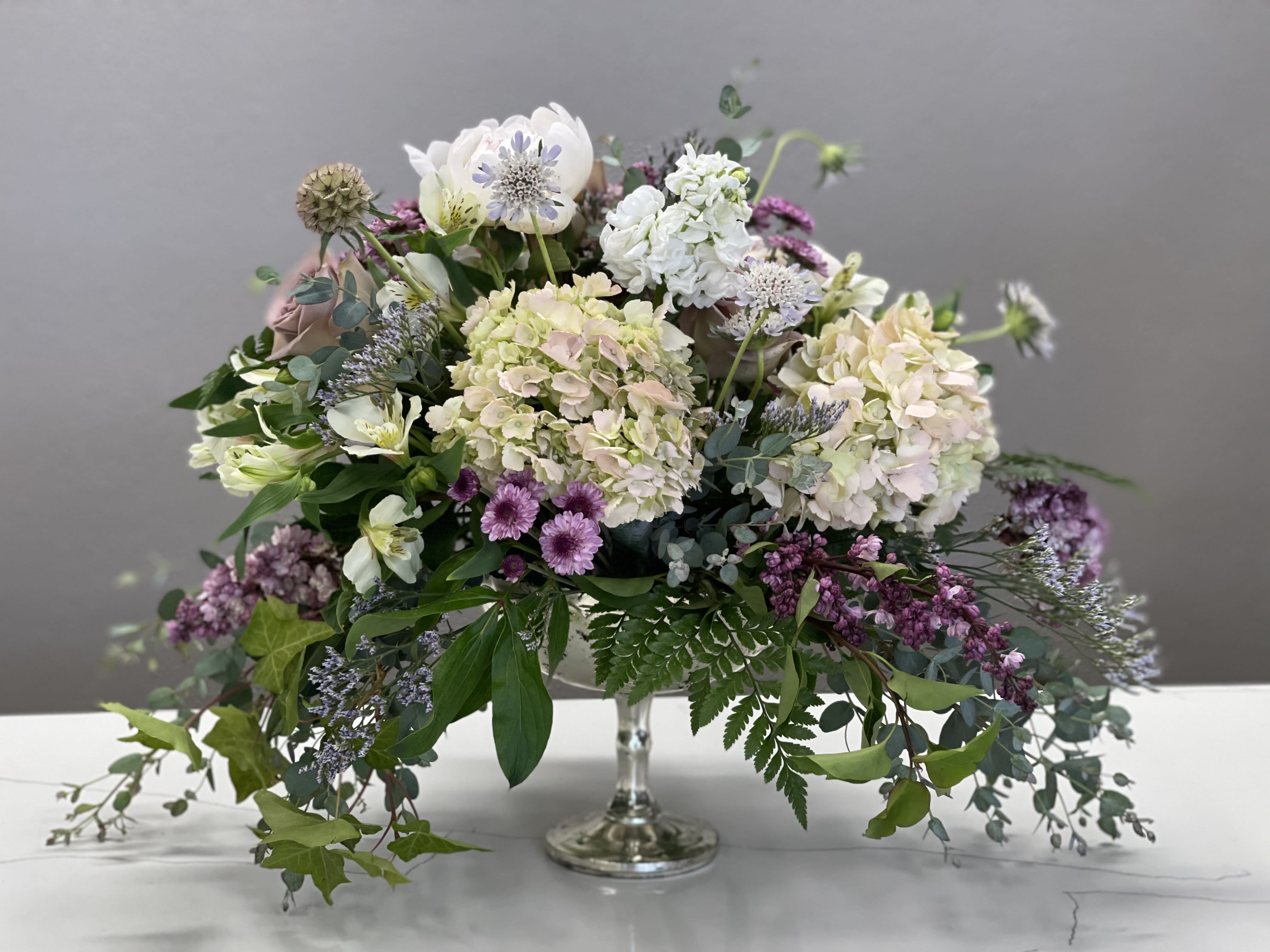 Soft and Muted - Delicate pastels blended together to create a serene and elegant arrangement. Perfect as a centerpiece while hosting a dinner party or sent as a floral hug to a loved one. 