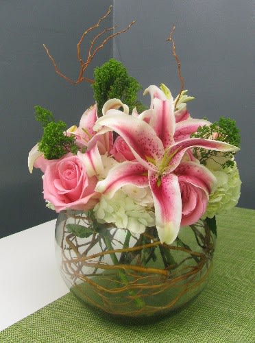 Lily Bowl Lily Bowl - Beautiful bouquet of lilies rested atop a bed of hydrangeas and pink garden roses. This is an ideal arrangement for any occasion.