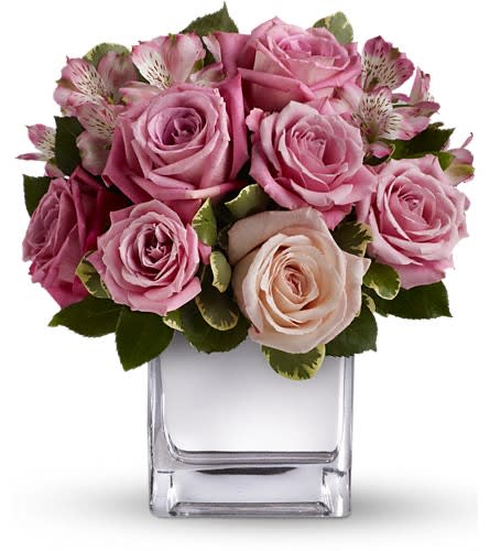 Teleflora's Rose Rendezvous Bouquet Teleflora's Rose Rendezvous Bouquet - This tastefully terrific bouquet features soft pink and lavender roses in a sleek contemporary silver cube vase. Understated and spectacular at the same time it is a gorgeous gift that she'll long remember. The exquisite bouquet includes light pink roses medium pink roses lavender roses and pink alstroemeria accented with fresh greenery.Delivered in contemporary glass cube with a mirrored silver finish.Approximately 10 1/2" W x 11 1/2" H Orientation: One-Sided As Shown : T405-1ADeluxe : T405-1BPremium : T405-1C