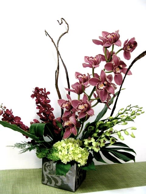 Exotic cymbidium Exotic cymbidium - Wonderful arrangement design with orchids such as cymbidiums and dendrobiums with a combination of green hydrangea.