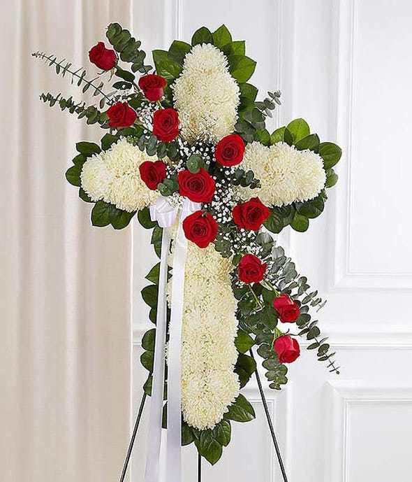Red & White Standing Cross With Red Rose Break Red & White Standing Cross With Red Rose Break - This beautiful sympathy rose spray is wonderful floral tribute shows your faith, hope and love during this difficult time. This standing spray arrangement - in the shape of a cross - is created from fresh white mums, red roses, spiral eucalyptus and more. Traditionally sent directly to the funeral home by family members or friends and displayed on a stand. Due to the sensitivity of the occasion, our florists use only the freshest flowers available, so varieties and colors may vary.