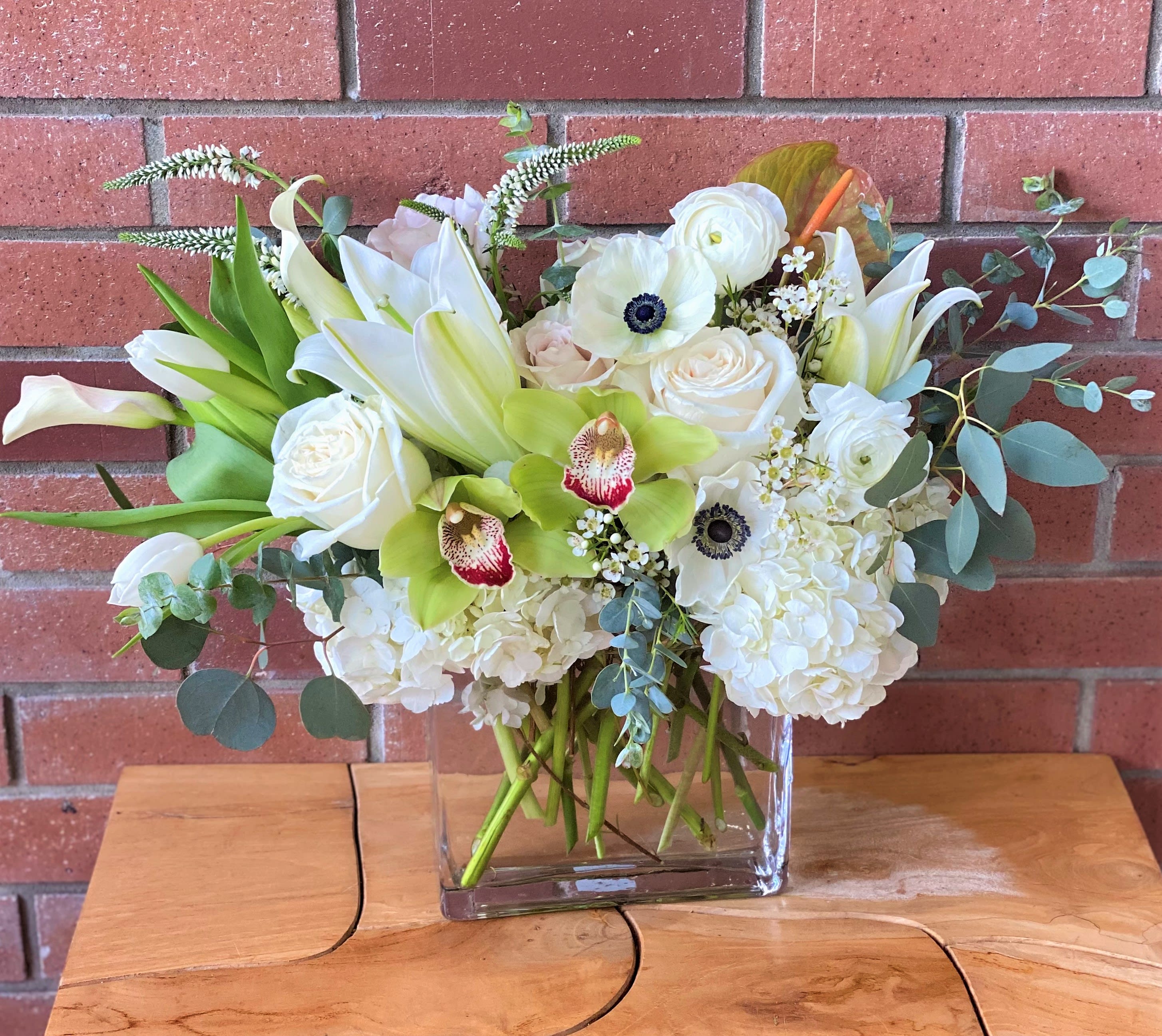 Sublime White Bouquet - A modern and elegant floral design that includes white garden roses, ranunculus, anemones, orchids, hydrangeas, oriental lilies, calla lilies, tulips, veronica , eucalyptus and premium fillers arranged in a 6 inch rectangular glass vase Pictured size &quot;Standart&quot;