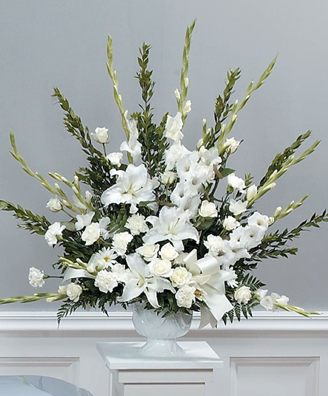 Simple Spirit - A large pedestal arrangement for the service. Includes gladiolus, carnations, lilies, roses and daisies. Simple, pure, elegant and sympathy appropriate. 
