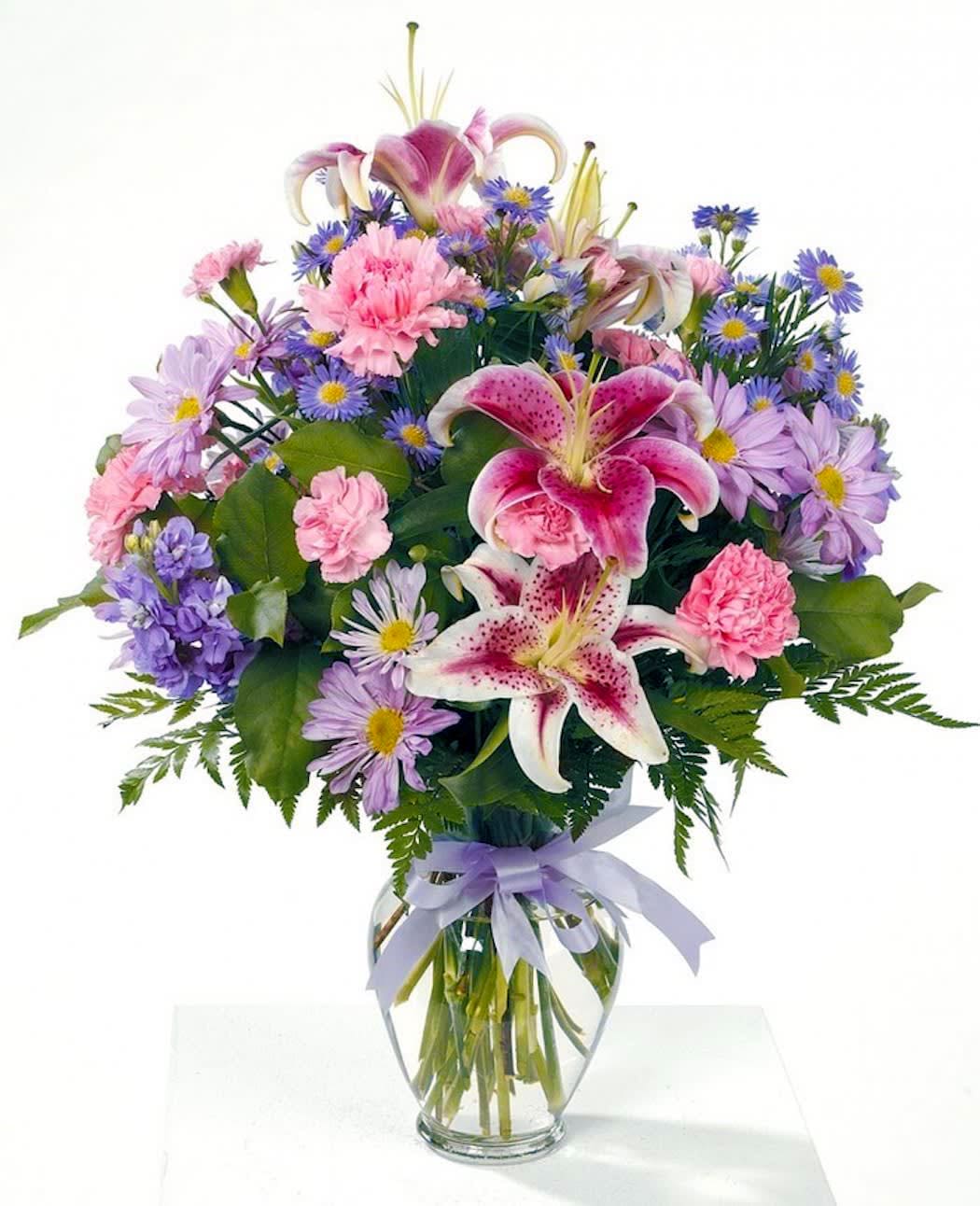 Fragrant Garden  - Beautiful stargazer lilies in a glass vase with pink carnations, lavender daisies and stock. Complimented with a satin ribbon bow. 