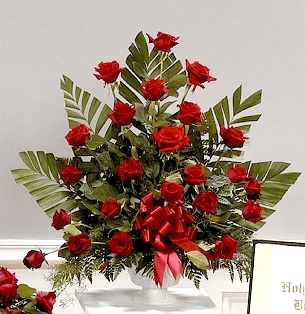Red Rose Garden - A full urn vase arrangement of red roses and palm leaves and fern to show your genuine sentiment. May also be done in other colors including white, yellow, pink, lavender based on availability.  Complimenting bow to match. 