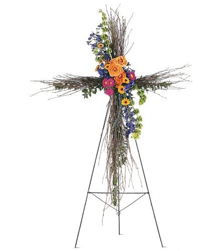 TF203-4  Birch Compassion Cross - A natural birch cross decorated with colorful flowers offers faith and compassion in a simple, yet beautiful way. One natural birch cross on an easel arrives with a cluster of vibrant fresh flowers including asters, roses and delphinium. Approximately 36&quot; W x 51&quot; H 