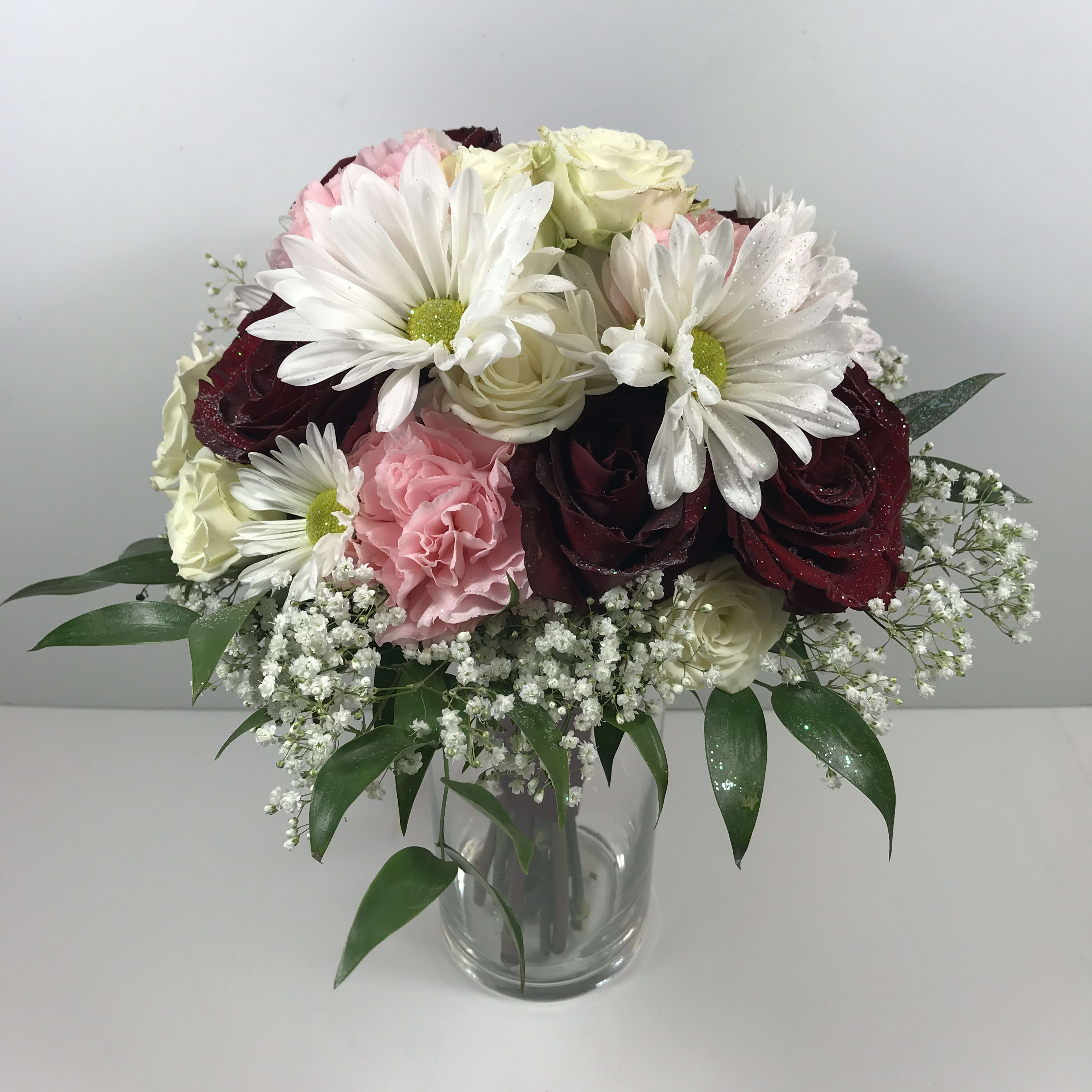 C67 Burgundy, Pink and White Prom Clutch  - This sweet prom clutch features burgundy roses, white spray roses, pink carnations and white daisies.  Each prom order is customized for you and your date's lovely gown.